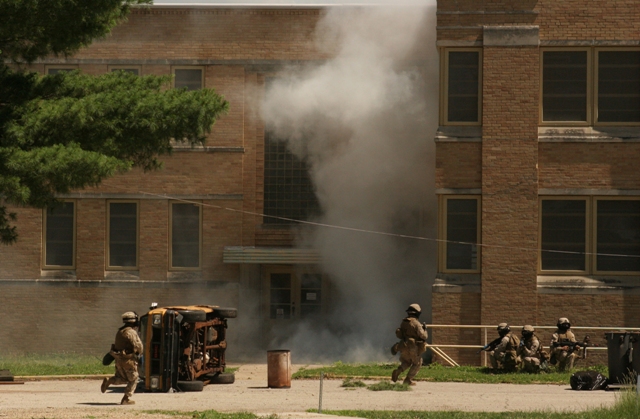 Muskatatuck Urban Training Cntr., Indiana, United States-Marines from Battalion Landing Team 2/6, 26th Marine Expeditionary Unit, move between buildings during training, June 10, 2008, at Muscatatuck Urban Training Center in Butlerville, Ind. The Marines were using the facility during the 26th MEU's Realistic Urban Training exercise, part of the MEU's predeployment training period. (Official USMC photo) (Released), 6/10/2008 10:33 AM.